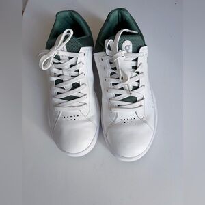 On Running White and Green Athletic Shoes